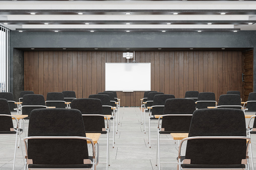 Front view of a gray marble reception desk with laptops standing on it in front of a modern office lighting wall. with wall design concrete and meeting room on gray tile floor. 3d rendering, mock up