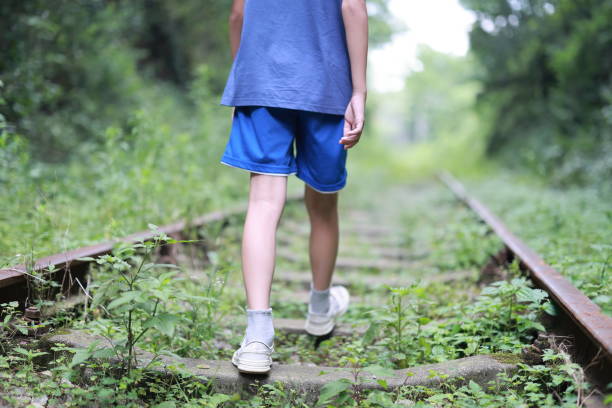 Boys walking on rail track