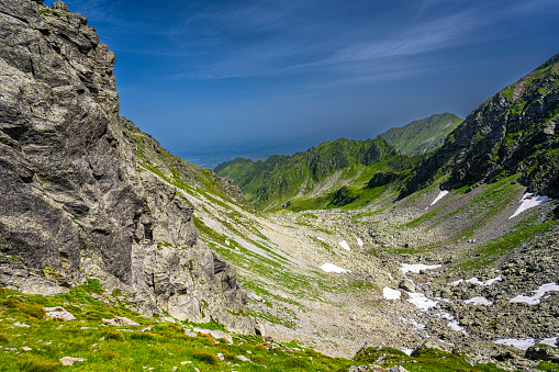 Summer landscape of the Fagaras Mountains. View from the hiking trail from Lake Balea to Mount Negoiu. Amazing rock formations of the Carpathians, Romania.