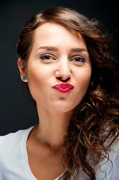 istock Woman with sensual smile on black background 159123513