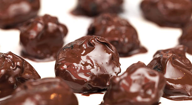 istock Homemade prunes in chocolate candies on white table background 159123872