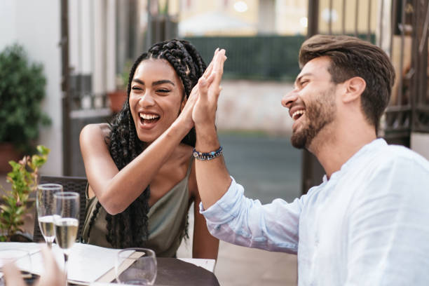 istock High-Five Moment at Outdoor Restaurant 1591239487