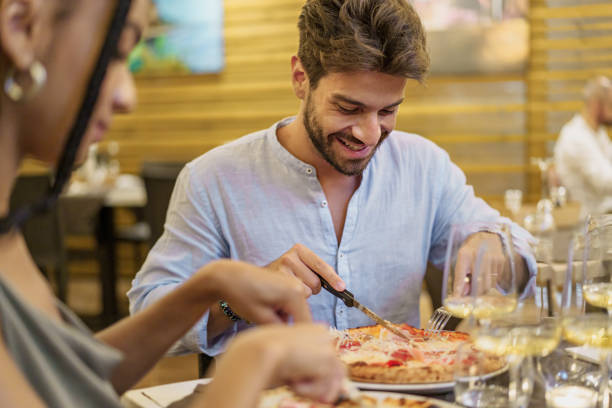 istock Man Enjoying Pizza in Courtyard Restaurant 1591239491