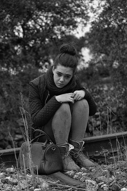 istock Young woman sitting on old railway 159126727