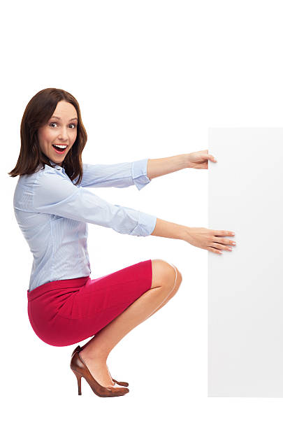 istock Businesswoman crouching by blank board 159127428