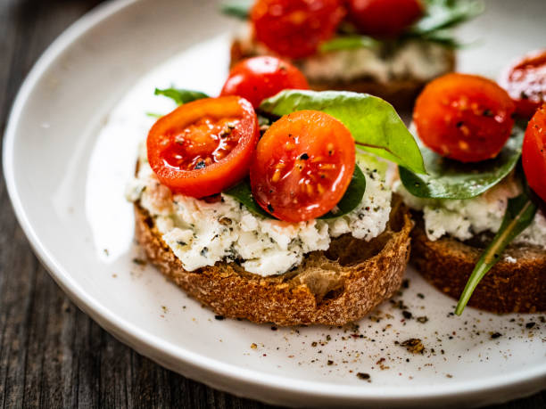 istock Breakfast - cottage cheese, bread and vegetables on wooden table 1591287278