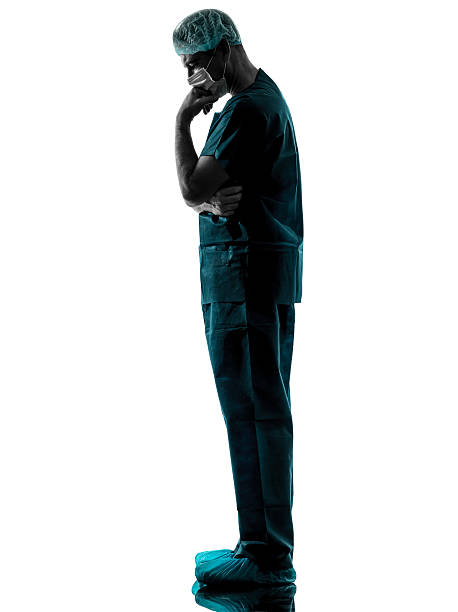 istock doctor surgeon man thinking with face mask full length silhouett 159134309
