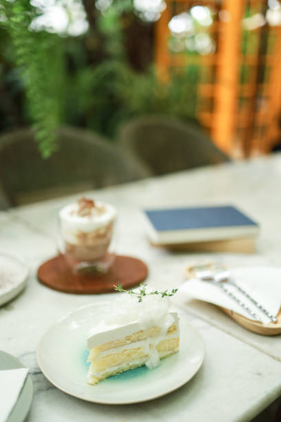 Coconut Cake and Coffee in a cafe on the blur background. traditional dessert Sliced of delicious coconut layer cake