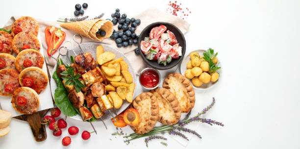 istock Family dinner or lunch. Many dishes on the table. Summer. 1591369973