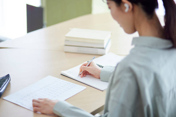 istock Japanese woman studying in the library 1591400388