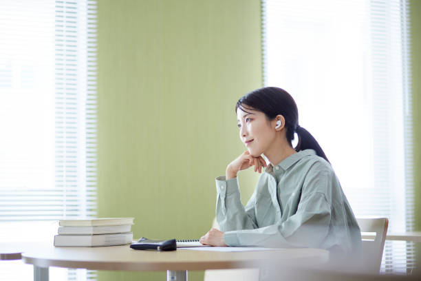 istock Japanese woman studying in the library 1591400402