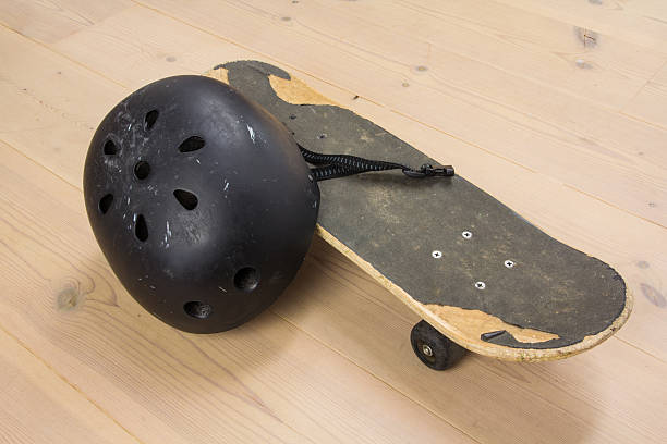 Skateboard and protective helmet stock photo