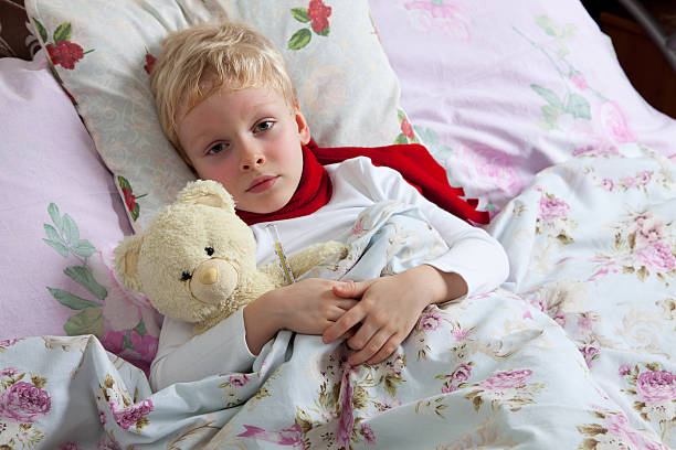 istock Sick boy lies in bed 159142126