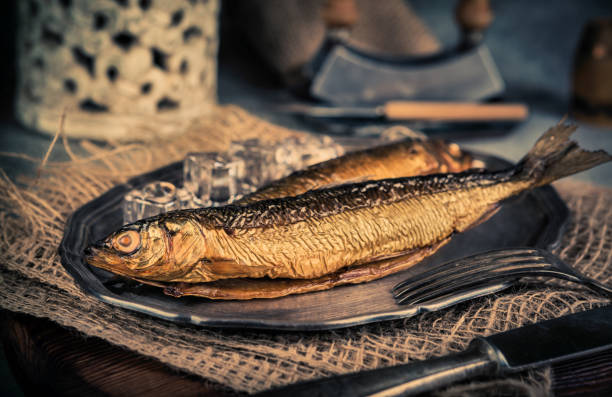 Smoked fish on a wooden background. Top view. Toned.