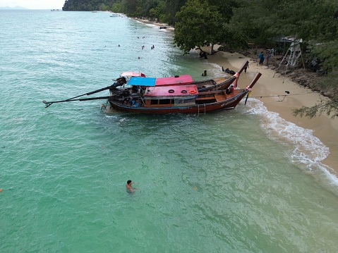 Tourists sunbathing at the Idyllic Freedom Beach in Phuket, a hidden strip of white sand near Patong, Thailand