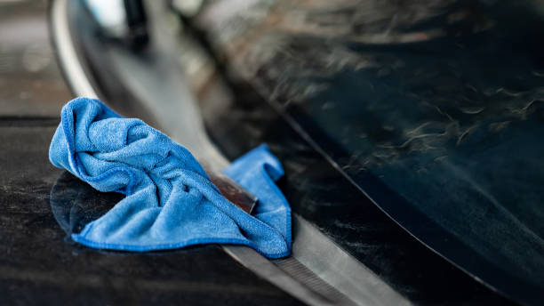 Blue cloth wipe or cleaning rag on car front windscreen