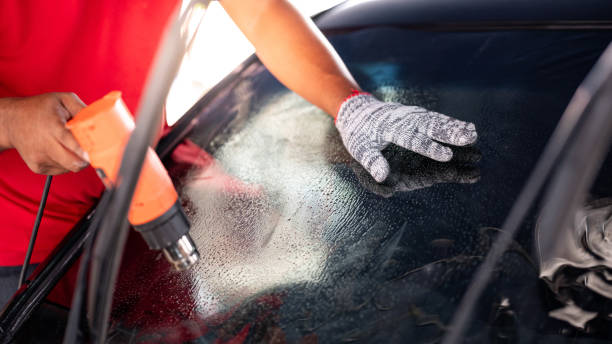 istock Car front windscreen film removal and tinting installation 1591460367