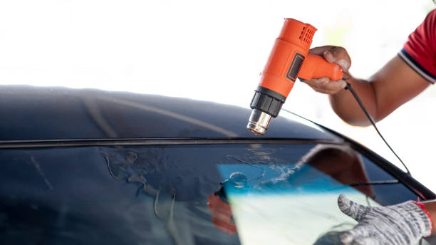 istock Car front windscreen film removal and tinting installation 1591463562