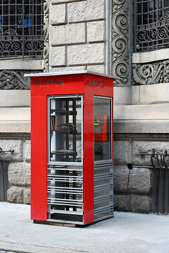 Oslo, Norway, July 7, 2023 - Free bookcase (open bookcase) in an old phone booth in downtown Oslo.