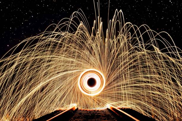 istock Closeup of a steel wool texture with circular patterns against a dark background. 1591489033