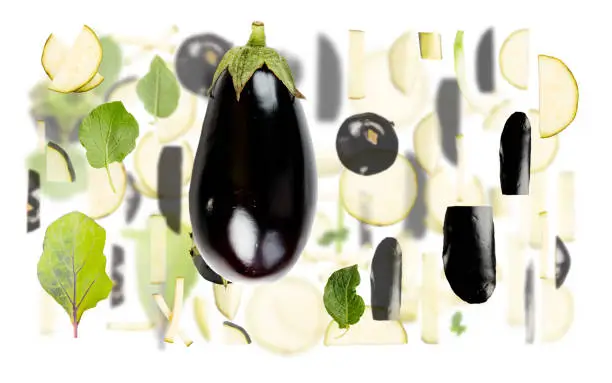 Abstract background made of Eggplant vegetable pieces, slices and leaves isolated on white.