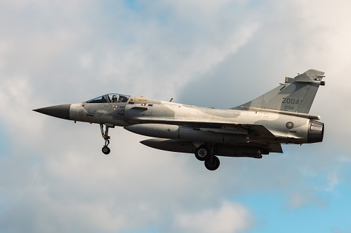 Hsinchu, Taiwan – January 19, 2022: A fighter jet of the Taiwan airforce soaring through a cloudy sky.