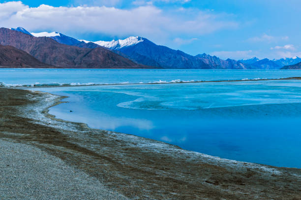 istock Enchanting Blue Hour: Fluffy Clouds Over Frozen Pangong Lake 1591501247