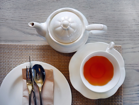 tea set in a composition with marshmallow flowers. Coffee mug on a saucer. on a light gray background. morning invigorating tea party