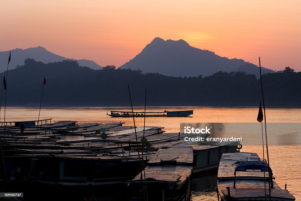 boats on the mekong river by sunset, laos boats on the mekong river in luang prabang at sunset, laos Asia Stock Photo