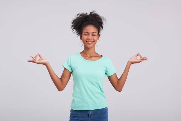 istock Stylish Stance: Woman's Mint Shirt and Blue Jeans Studio Posture 1591509717