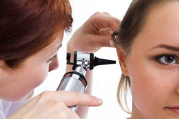 istock Otolaryngologist performing exam on patient 159151143