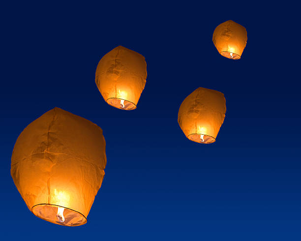 istock yellow paper lanterns in dark sky 159153154