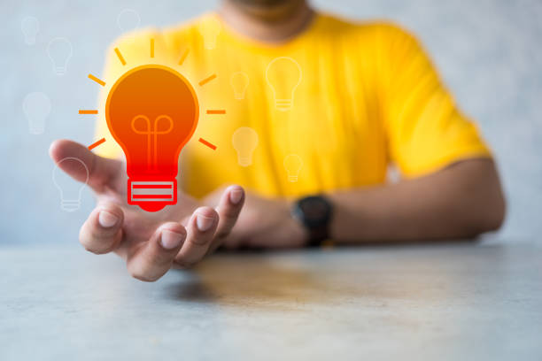 istock Hand of human holding icons with bulb light. Business technology creativity idea concept. 1591532084