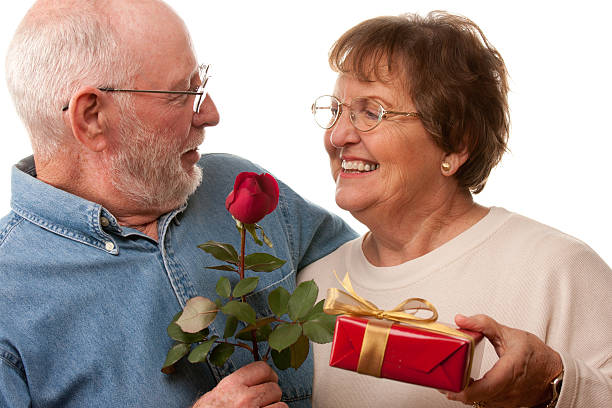 istock Happy Senior Couple with Gift and Red Rose 159153653