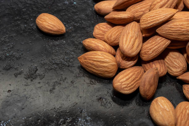 istock organic almond (prunus dulcis) on stone or concrete background 1591539073