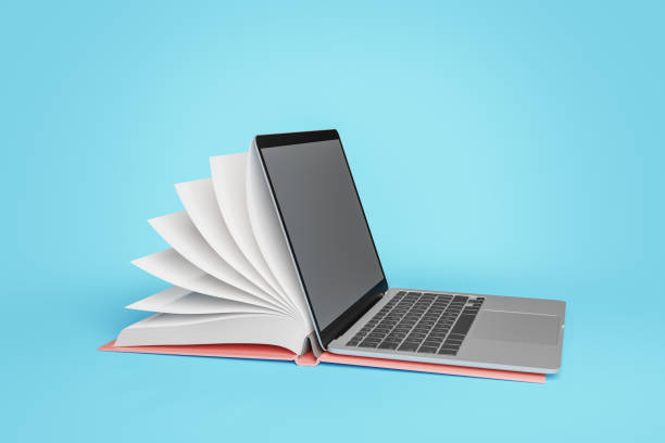 istock Opened laptop and notebook placed together against blue backdrop 1591544059