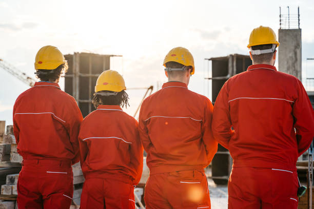 istock Rear-View Of Construction Workers On The Construction Site 1591566589