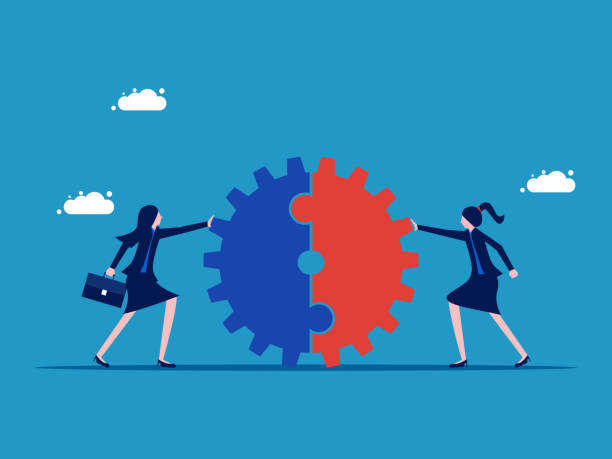 istock complete merger. Two businesswomen pushing a cogwheel together 1591569795