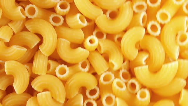 Uncooked Chifferi Rigati Pasta, Scattered Dry Macaroni - Rotating Background