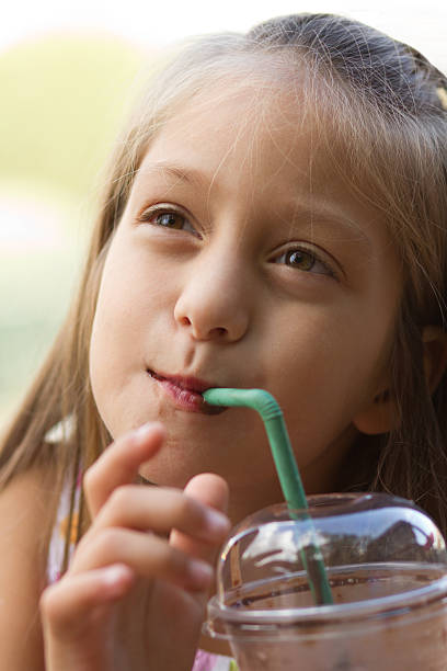 istock Funny little girl drinks milkshake 159161981
