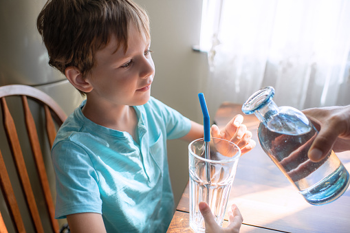 Child with a glass of water at home