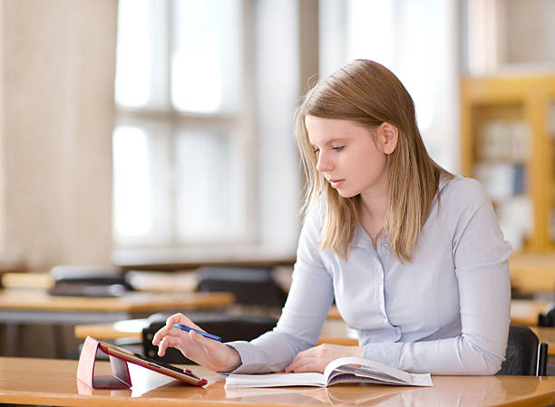 istock girl with touchpad in library 159164068