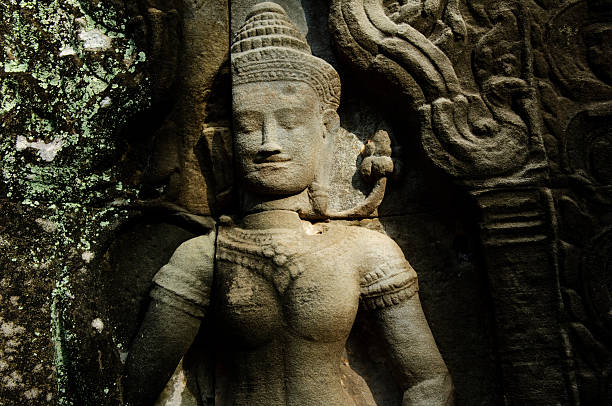Close-up view of a beautifully carved statue within the Angkor Wat temple complex in Cambodia.