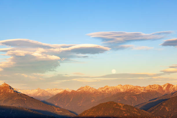 lenticular cloud above a the alps mountains and a full moon - light effect full moon mountain peak european alps imagens e fotografias de stock