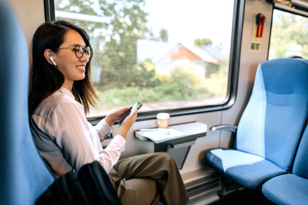 istock Smiling beautiful businesswoman enjoying a train ride 1591658310