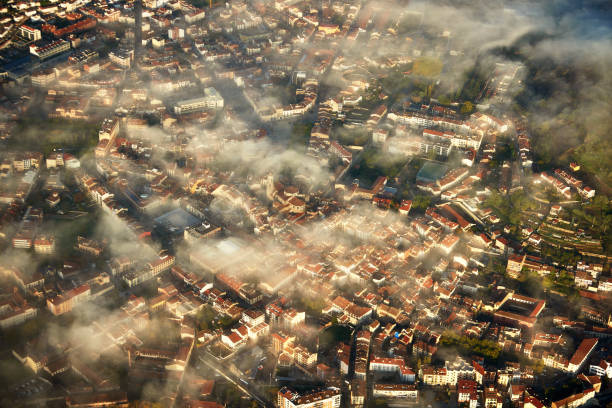 Aerial perspective from hot air balloon floating over capital city of Garrotxa, former medieval town in Province of Girona, Catalonia.