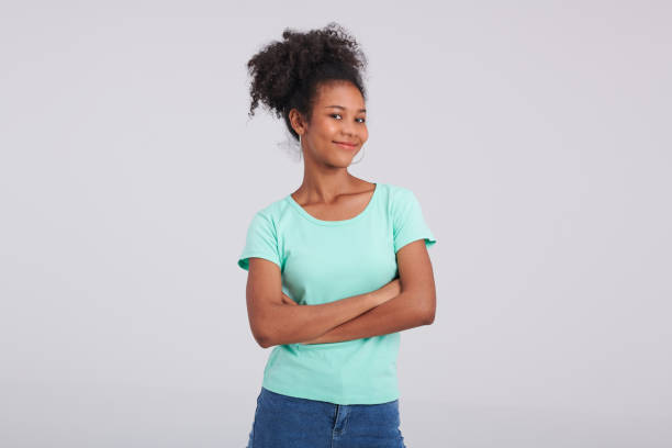 istock Dynamic Posture: Woman's Mint Shirt and Blue Jeans Studio Pose 1591661422