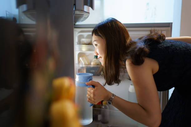 istock Woman finding a foods in refrigerator. 1591662046