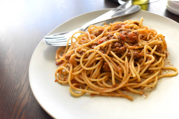 istock Spaghetti Bolognese with a fork on a plate. 1591665966