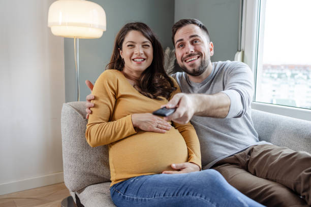 istock Expecting couple watching TV 1591670453